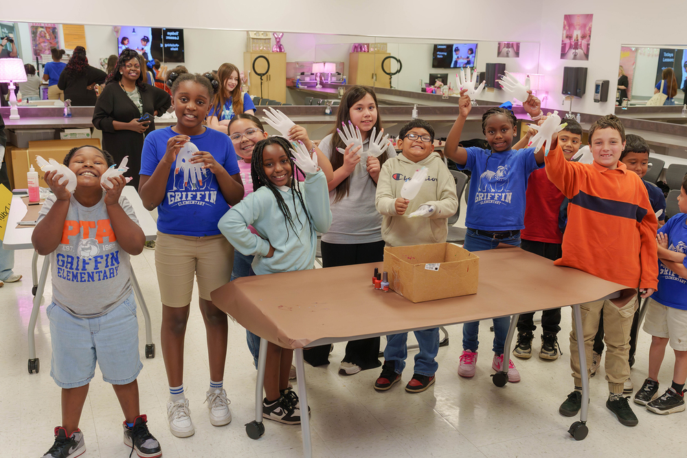 elementary age boys and girls waving