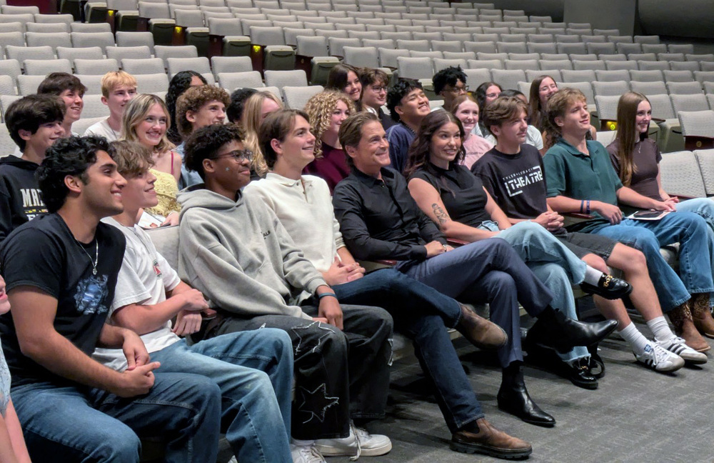 high school students in auditorium seating with Rob Lowe in middle of them