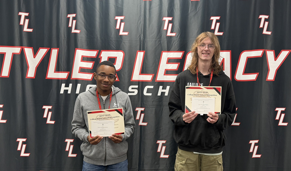 two teen boys holding certificates in front of Tyler Legacy backdrop