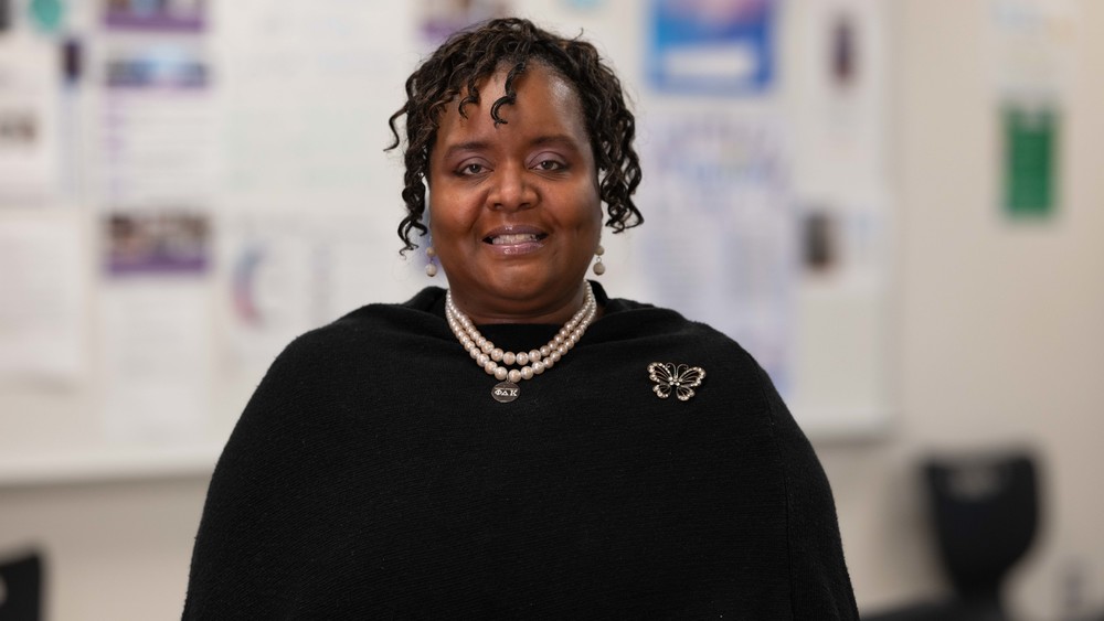 African American woman wearing black blouse and pearl necklace