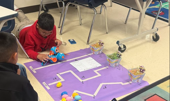 students coding robot to navigate down path