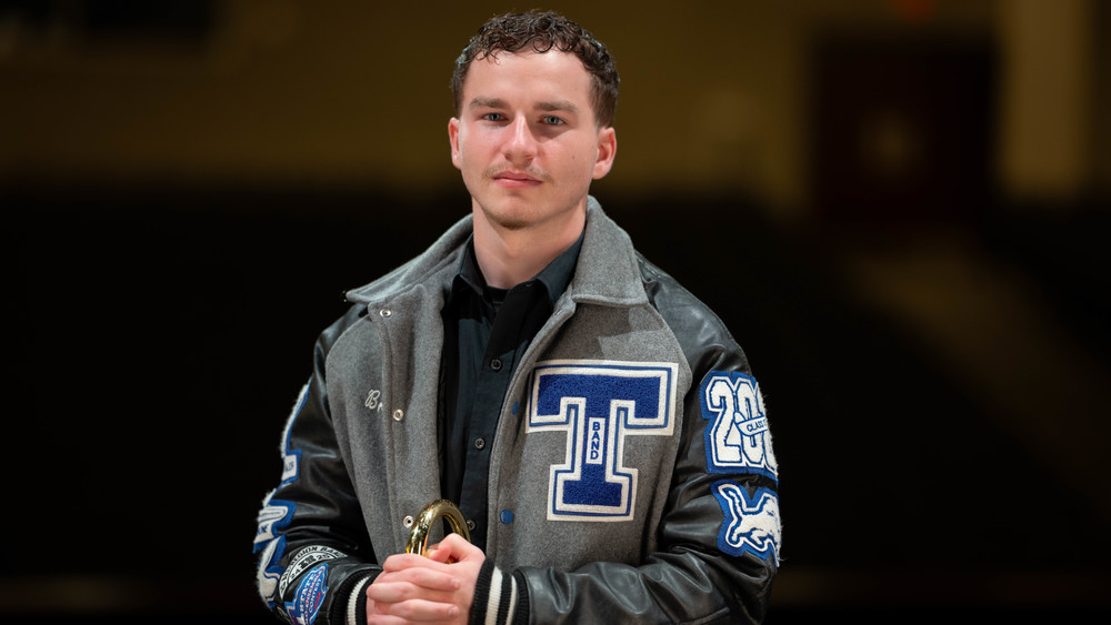 teen boy wearing his Tyler High letter jacket