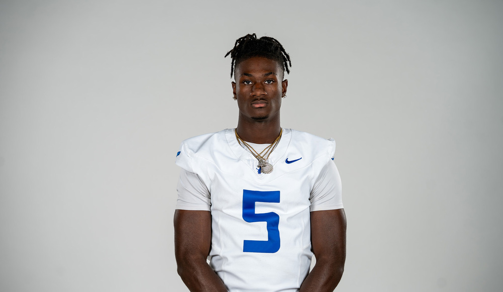 African American teen boy wearing football jersey