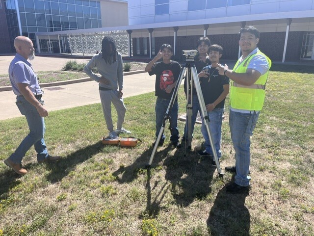 students using survey equipment
