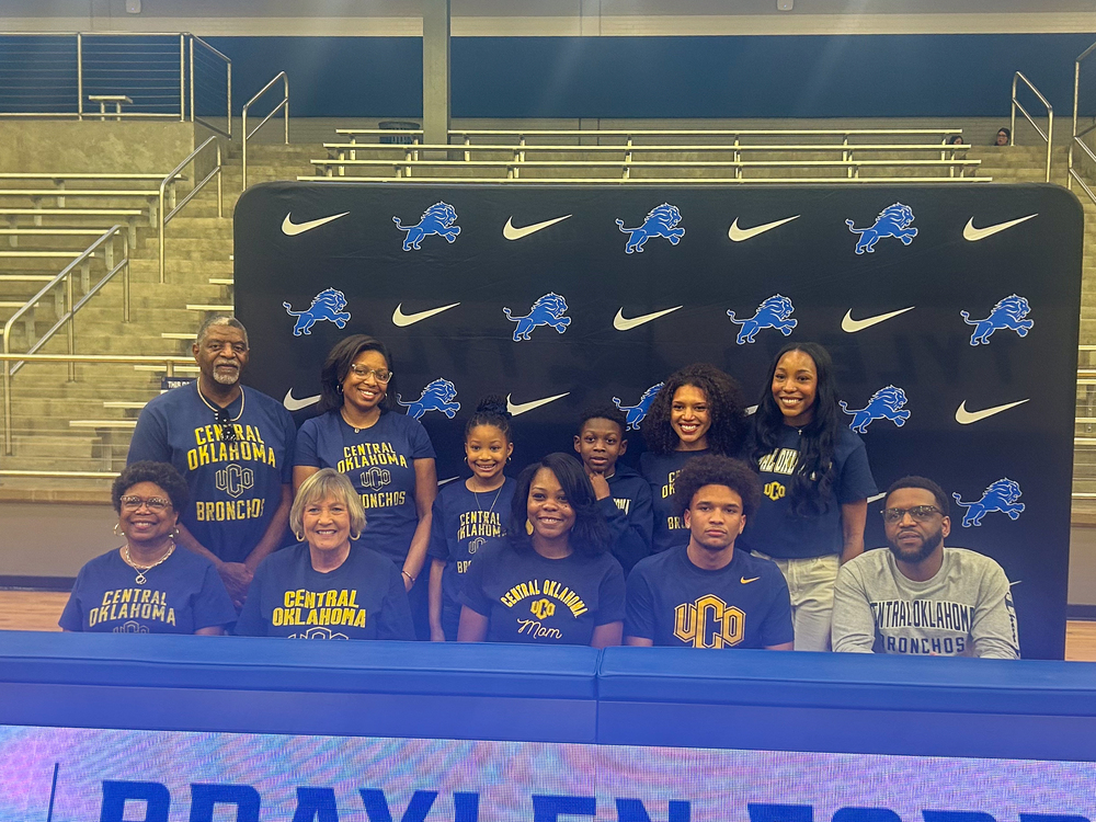 Tyler High student-athlete smiles with family and signs to Central Oklahoma to play at the collegiate level