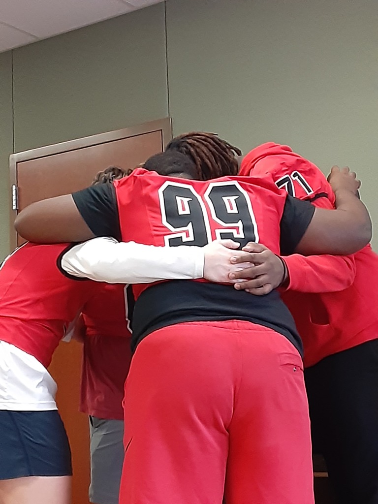 Football players in a huddle