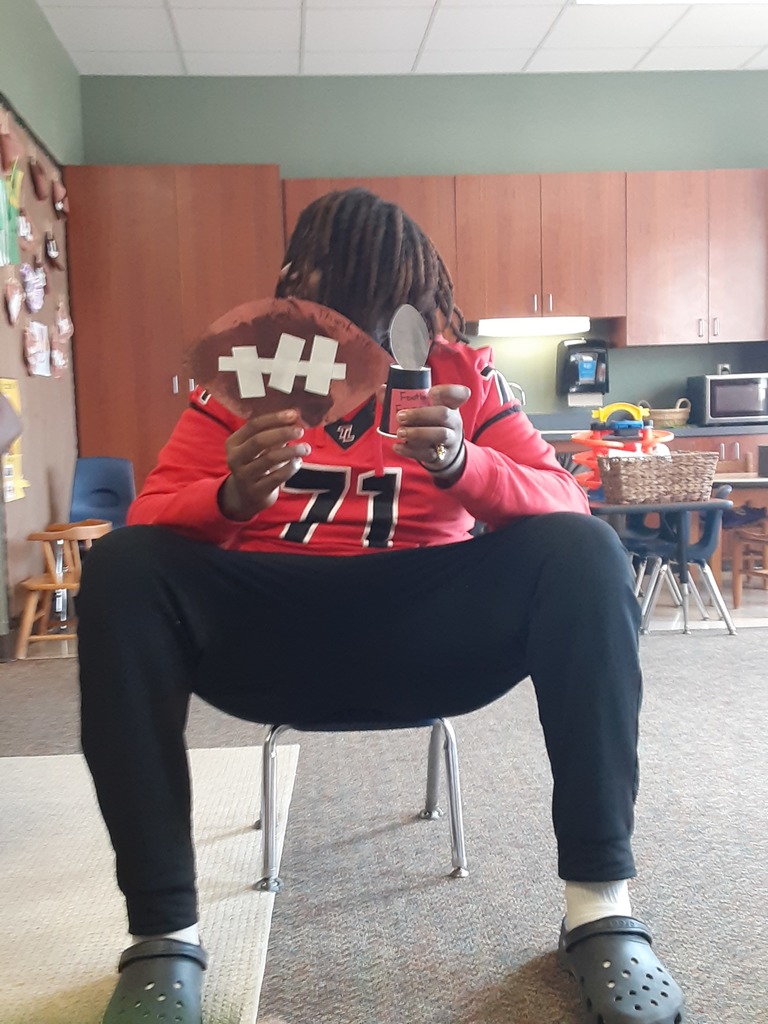 Football player holding a thank you card