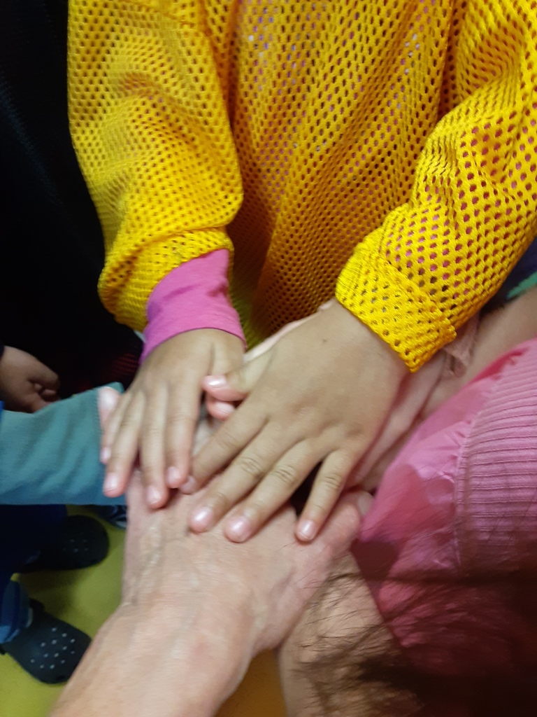 Hands together in a football huddle
