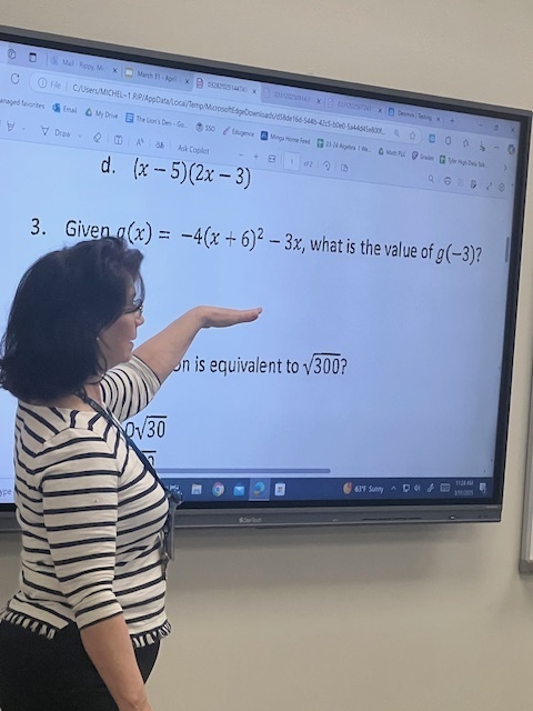 teacher at smart board giving a lesson