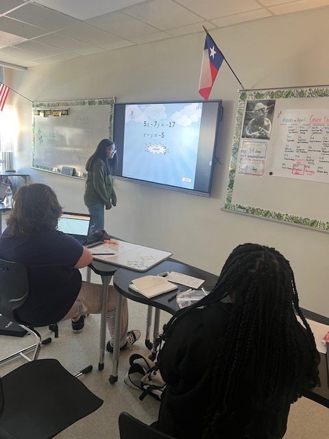 students at a smart board playing a game