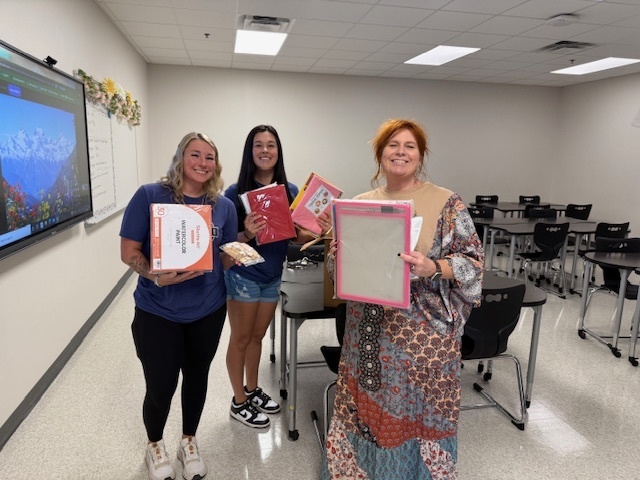 teacher and two ladies holding gifts