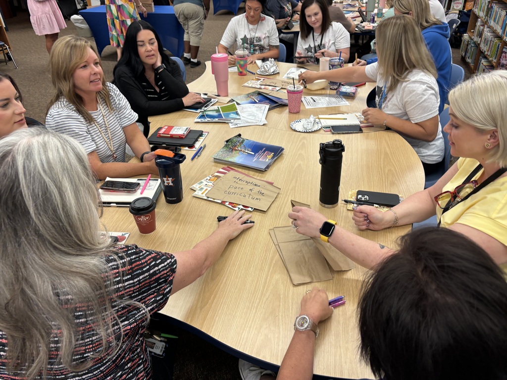 Teachers discussing and working together during a training