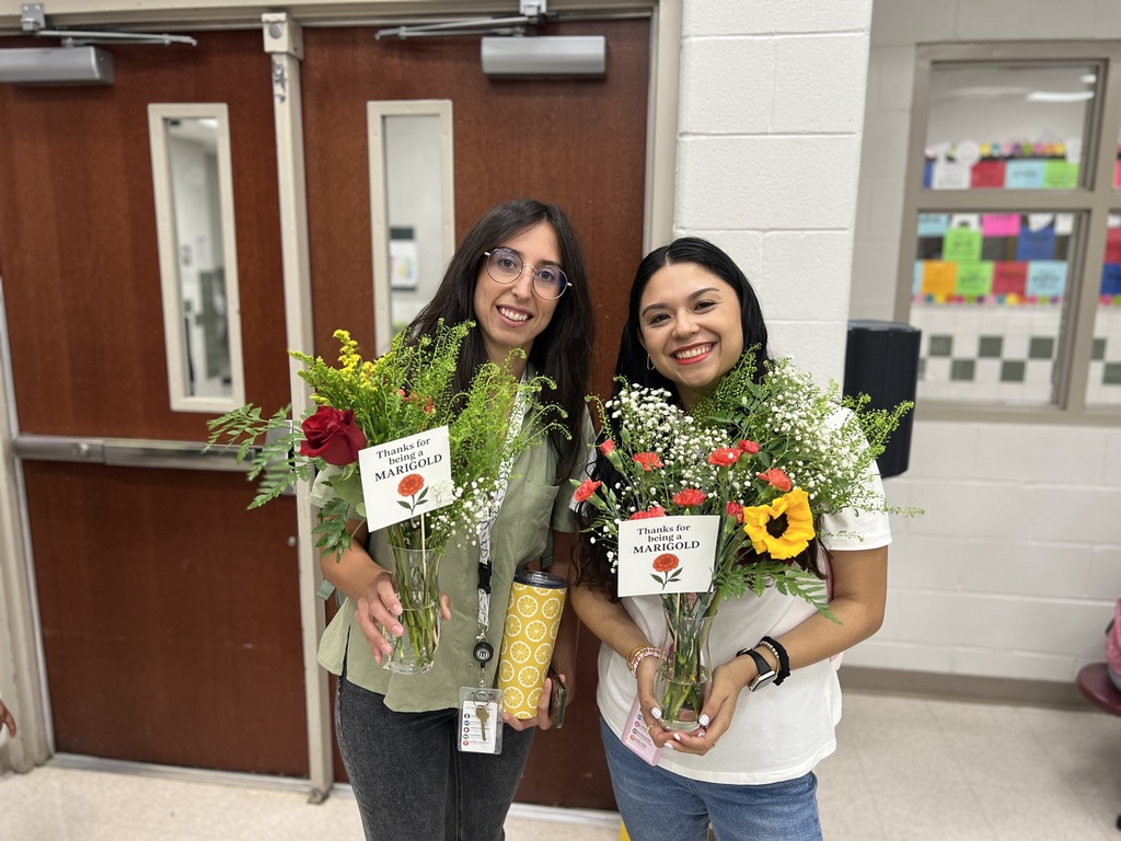 Two women holding flower bouquets
