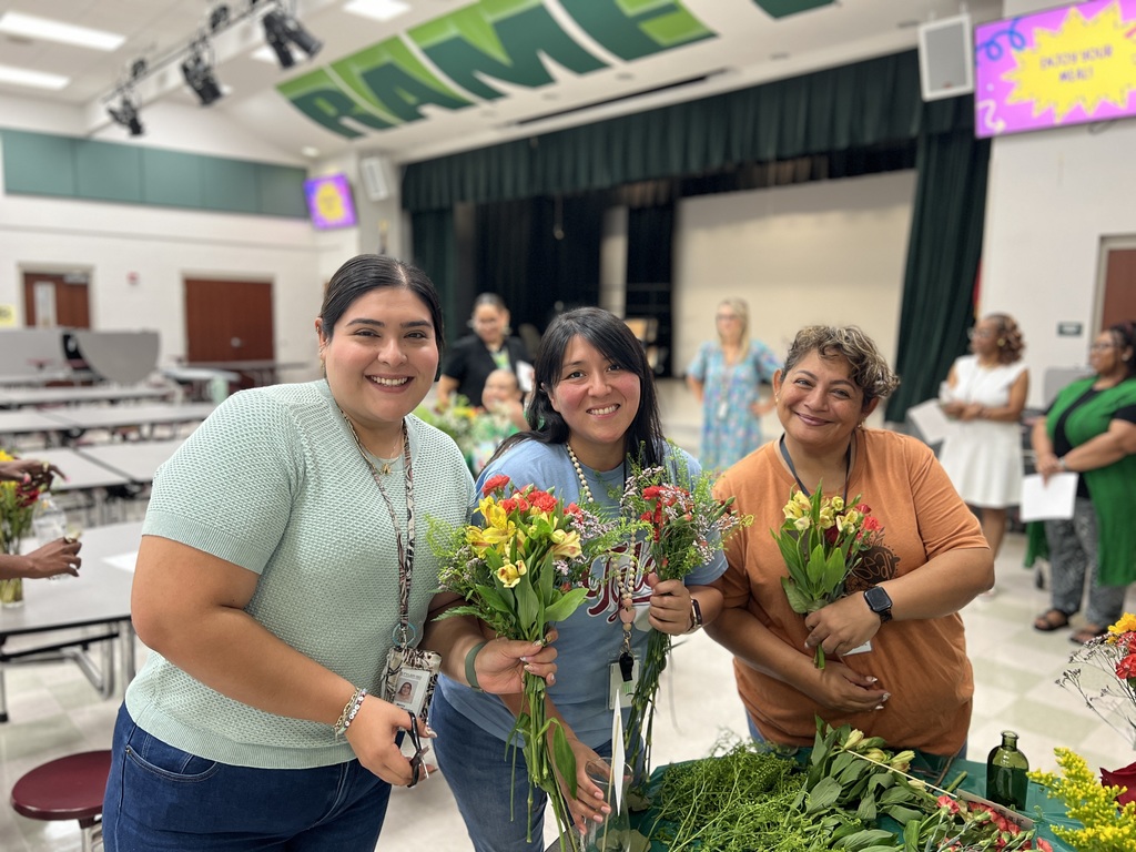 Three women holding floral bouquets