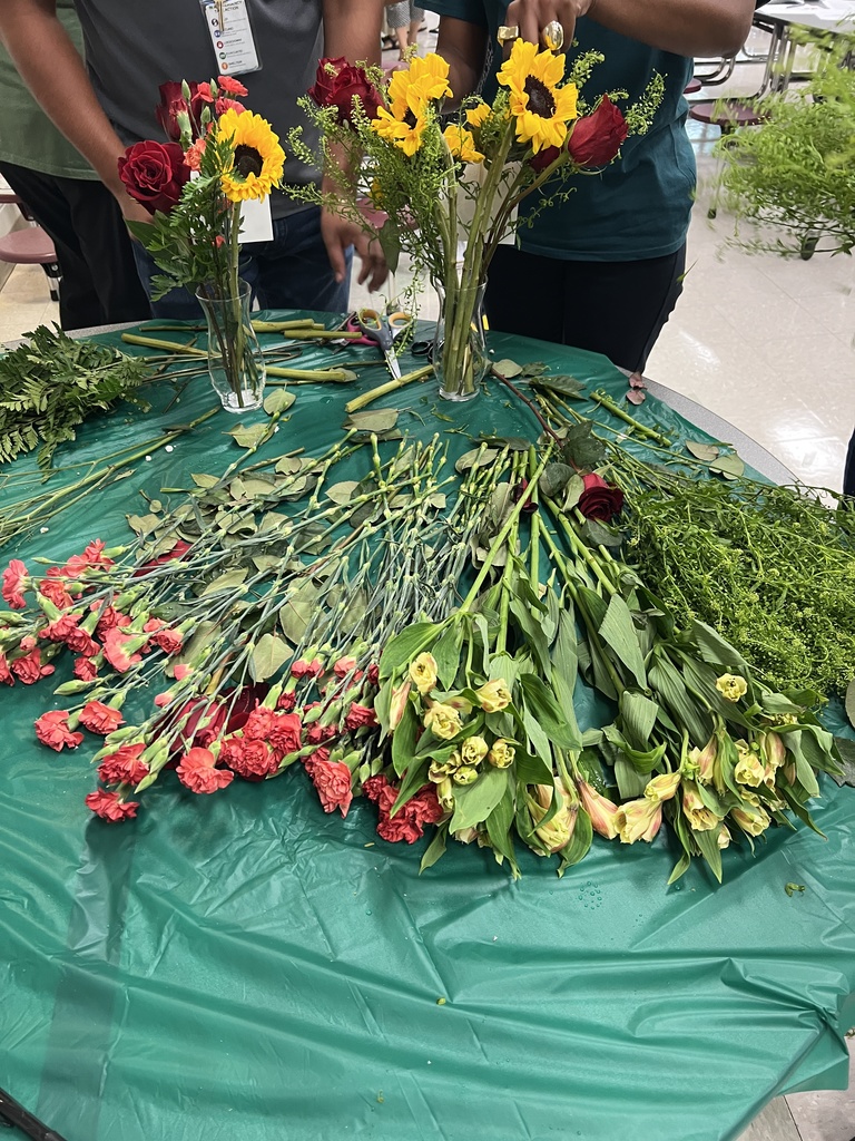 a table covered in long stem flowers