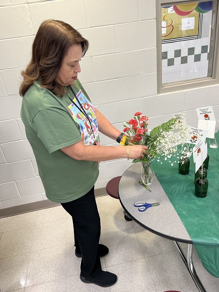 a woman building a bouquet of flowers