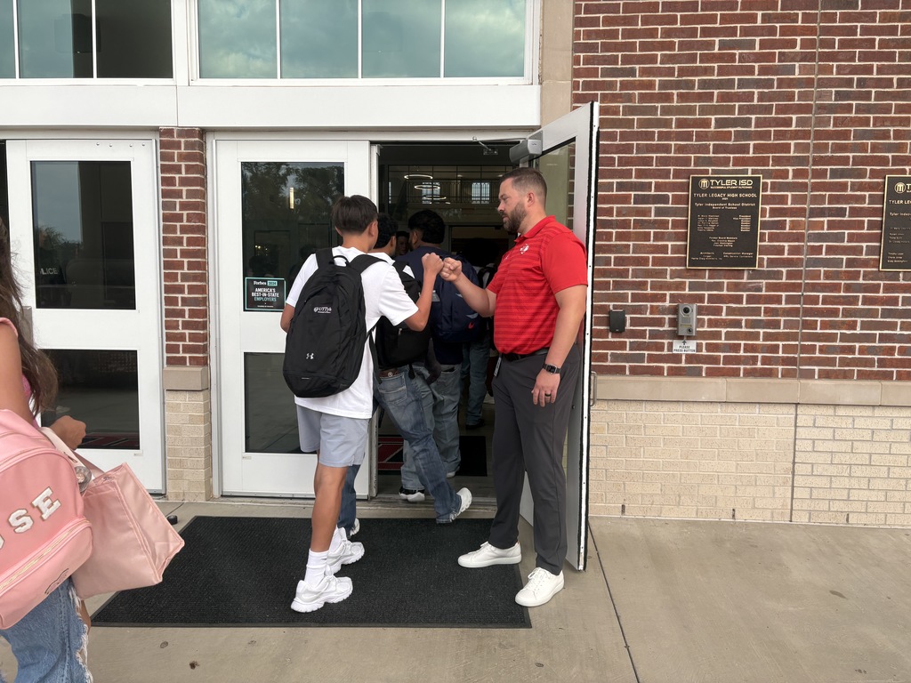 Prncipal Sherman greeting students on the first day of school