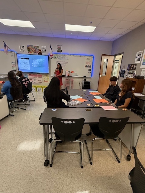 teacher in her class presenting to class