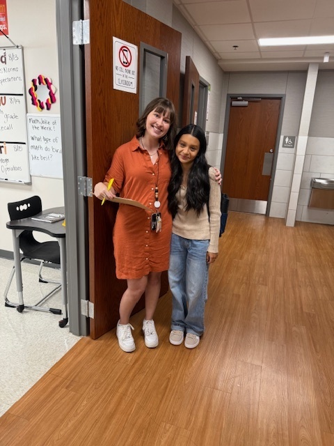 student and teacher at door