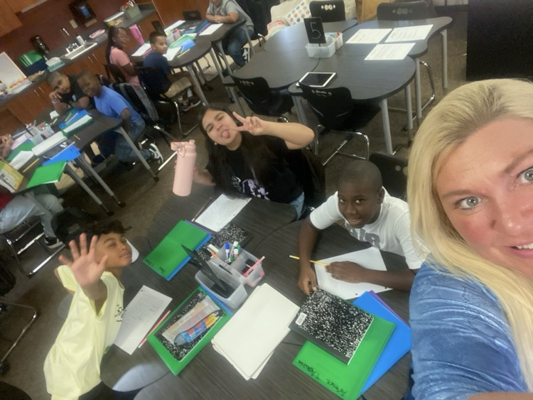 students smiling with teacher