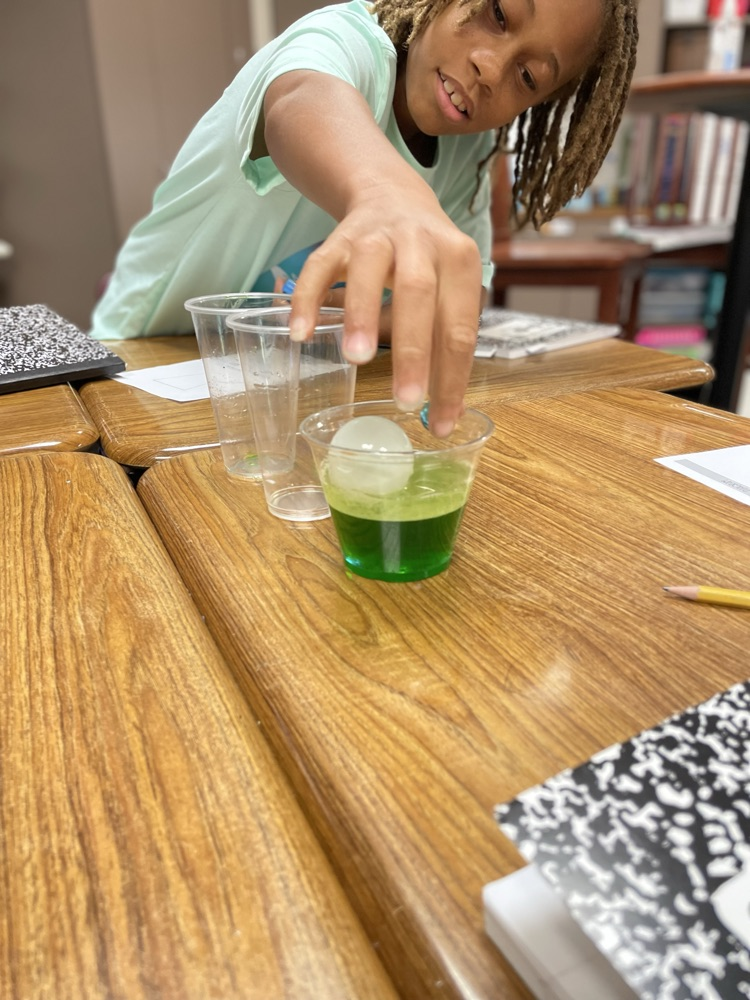 student creating a tower using the properties of matter