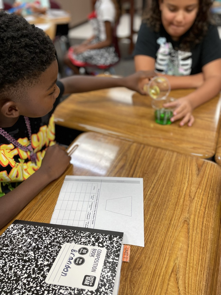 student creating a tower using the properties of matter