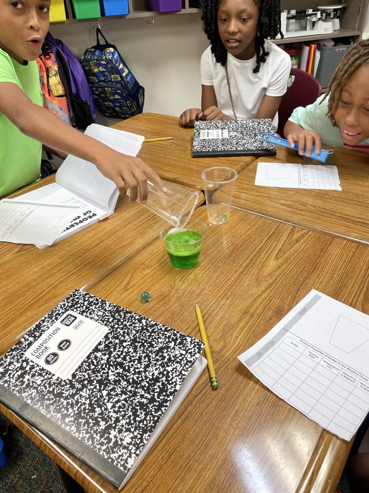 student creating a tower using the properties of matter