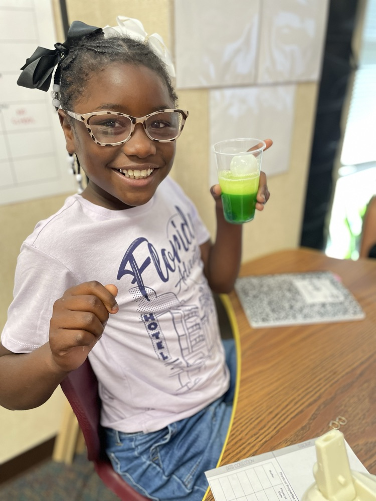 student creating a tower using the properties of matter