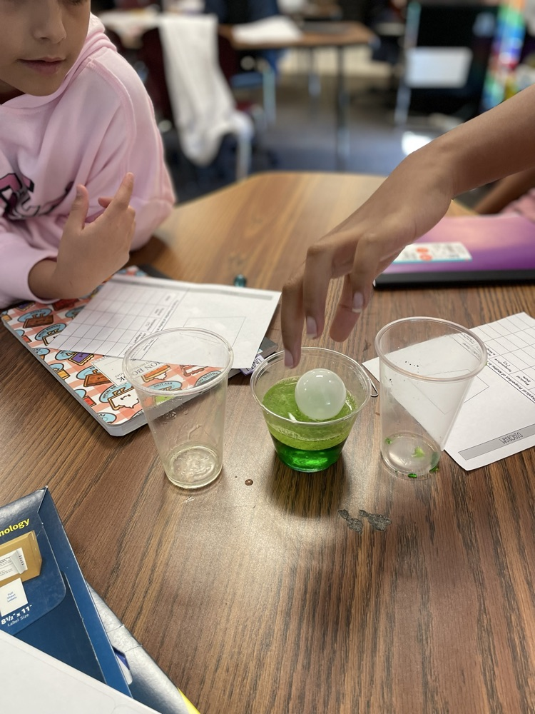 student creating a tower using the properties of matter