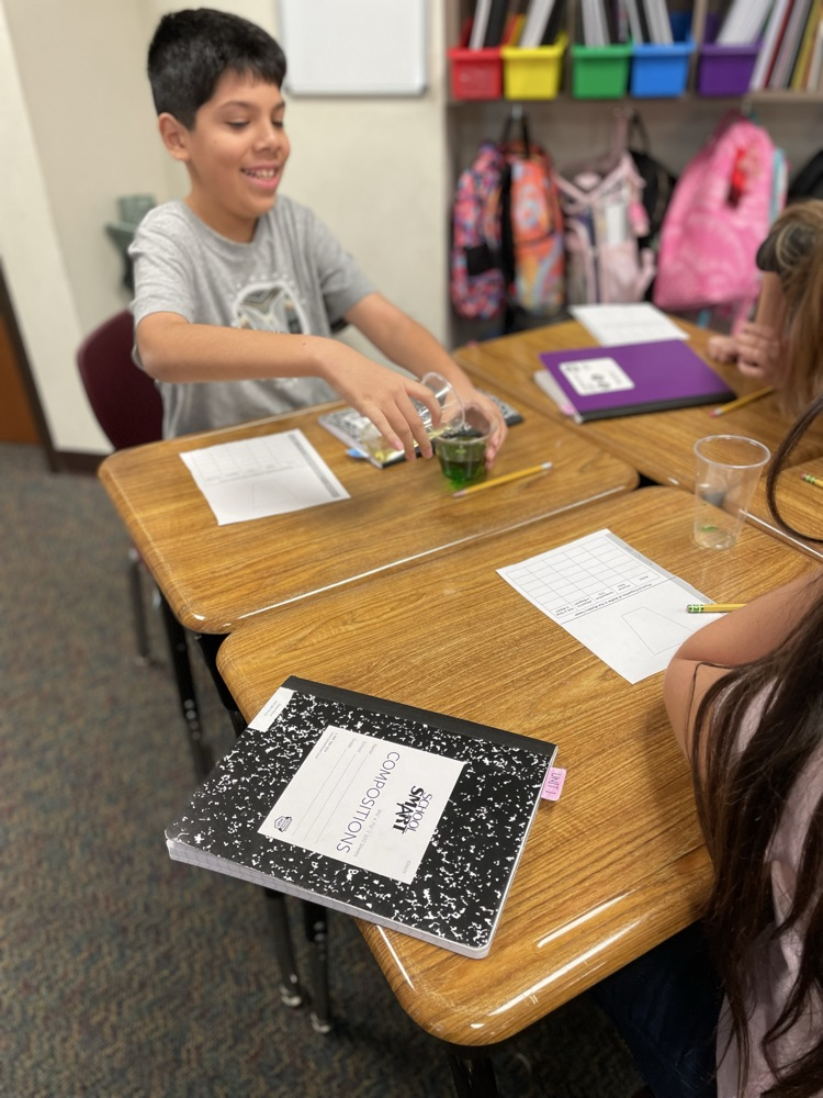 student creating a tower using the properties of matter