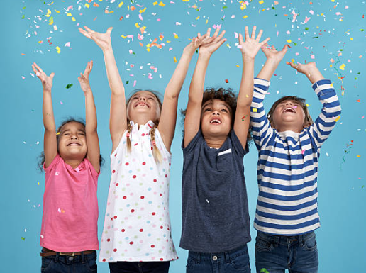 kids throwing confitti in the air