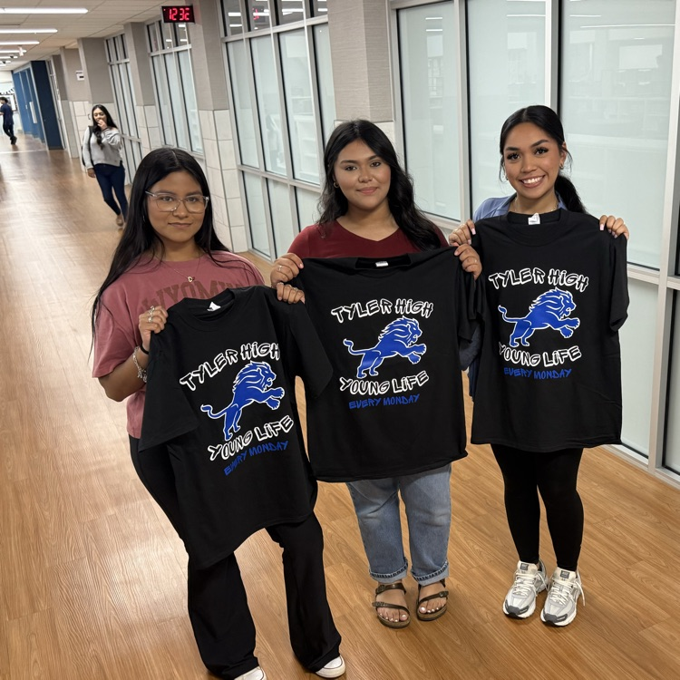 students holding tshirt