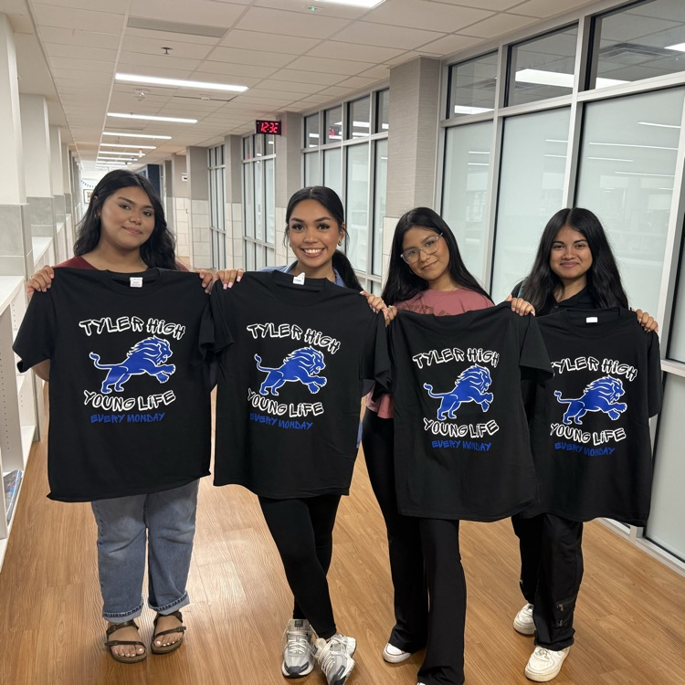 students holding tshirt