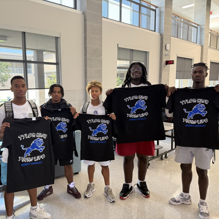 students holding tshirt