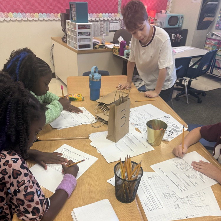 3rd graders feeling objects for texture and working together