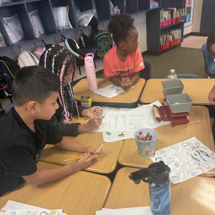 third graders working together to measure mass in a lab experiment