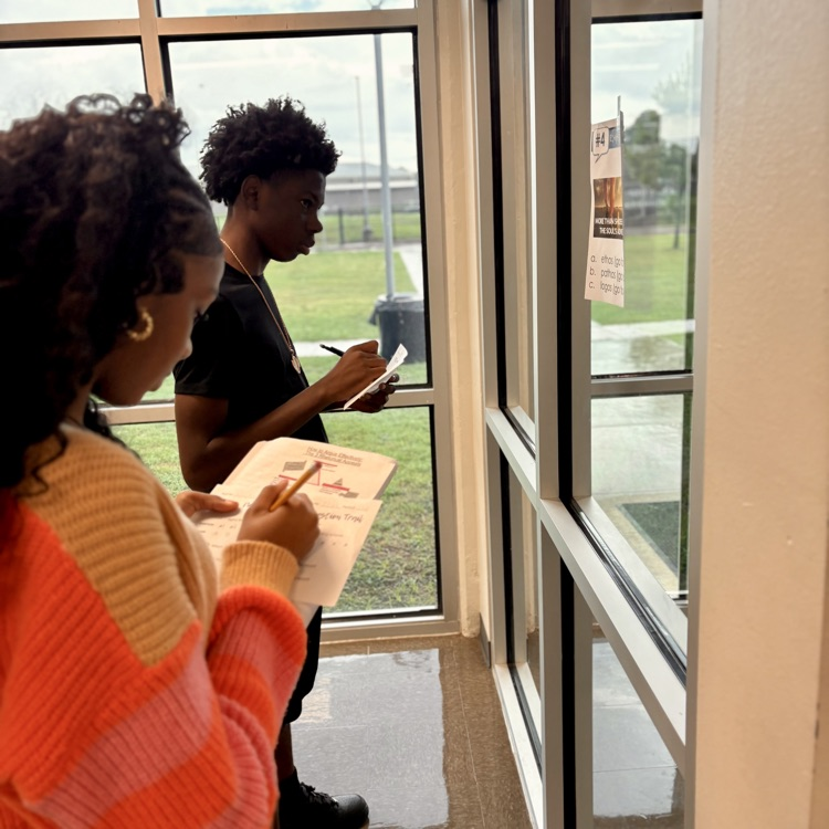 students taking notes over an advertisement