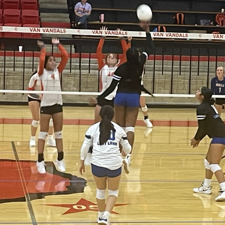 Volleyball player hitting ball