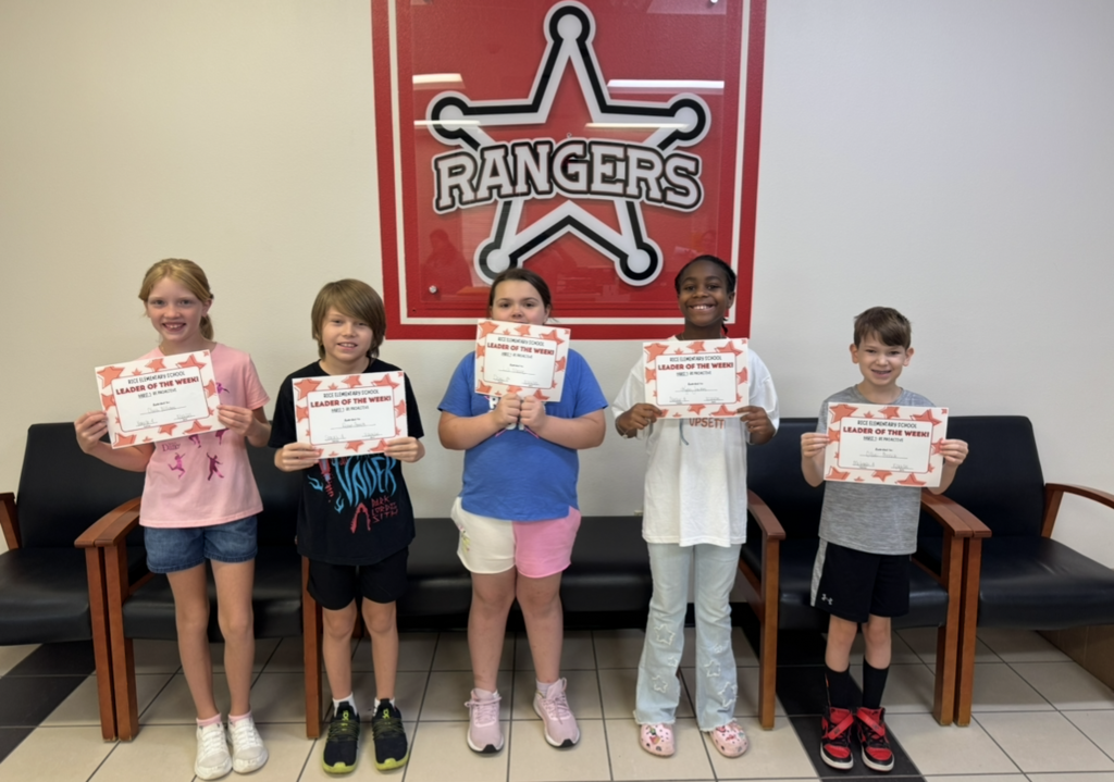 Students holding their Leader of the Week Certificate