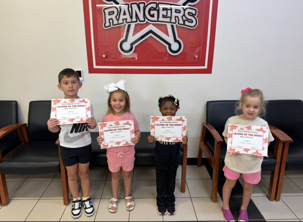 Students holding their Leader of the Week Certificate