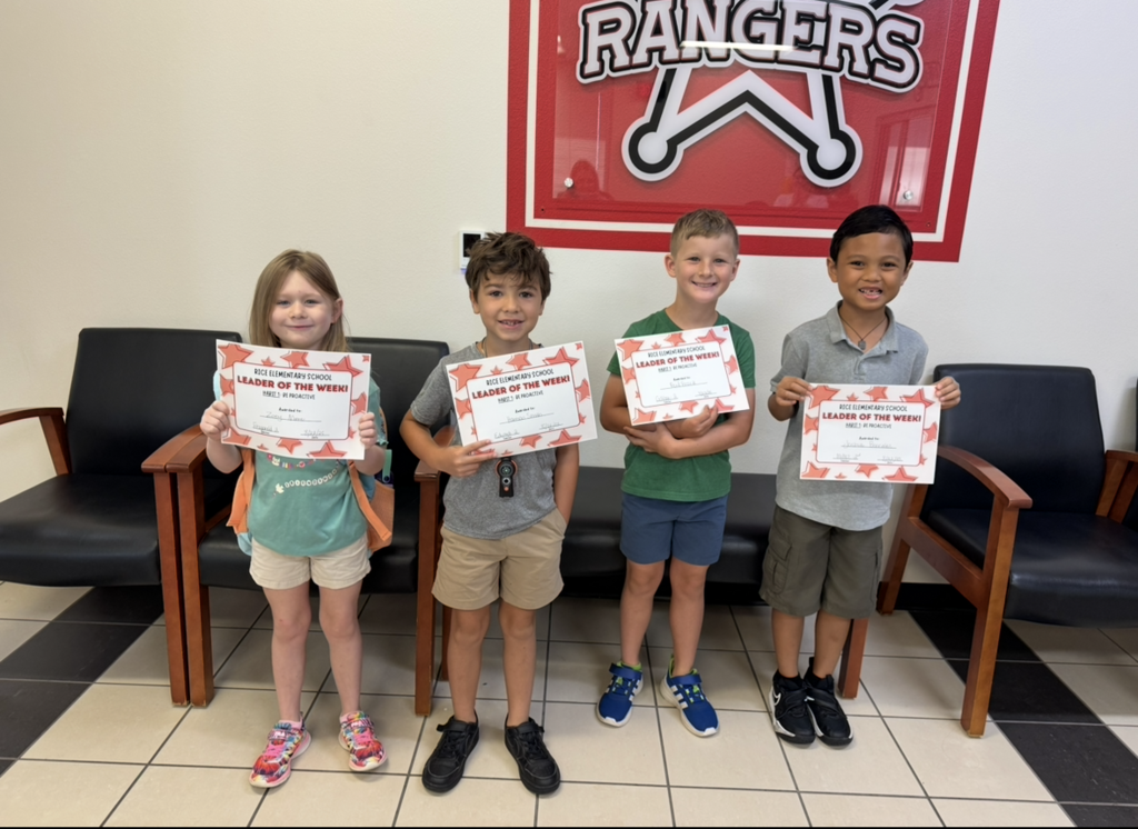 Students holding their Leader of the Week Certificate