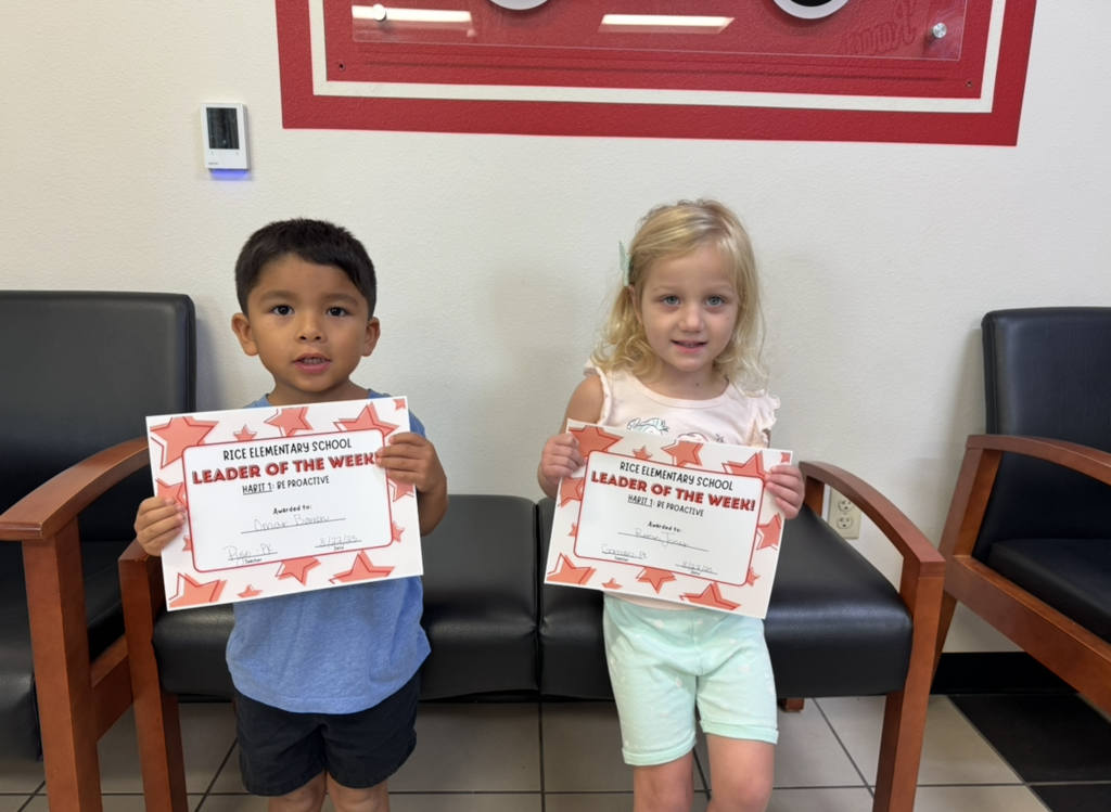 Students holding their Leader of the Week Certificate