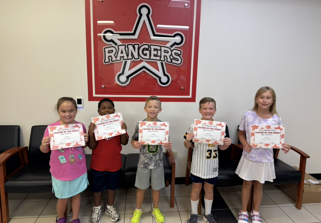 Students holding their Leader of the Week Certificate