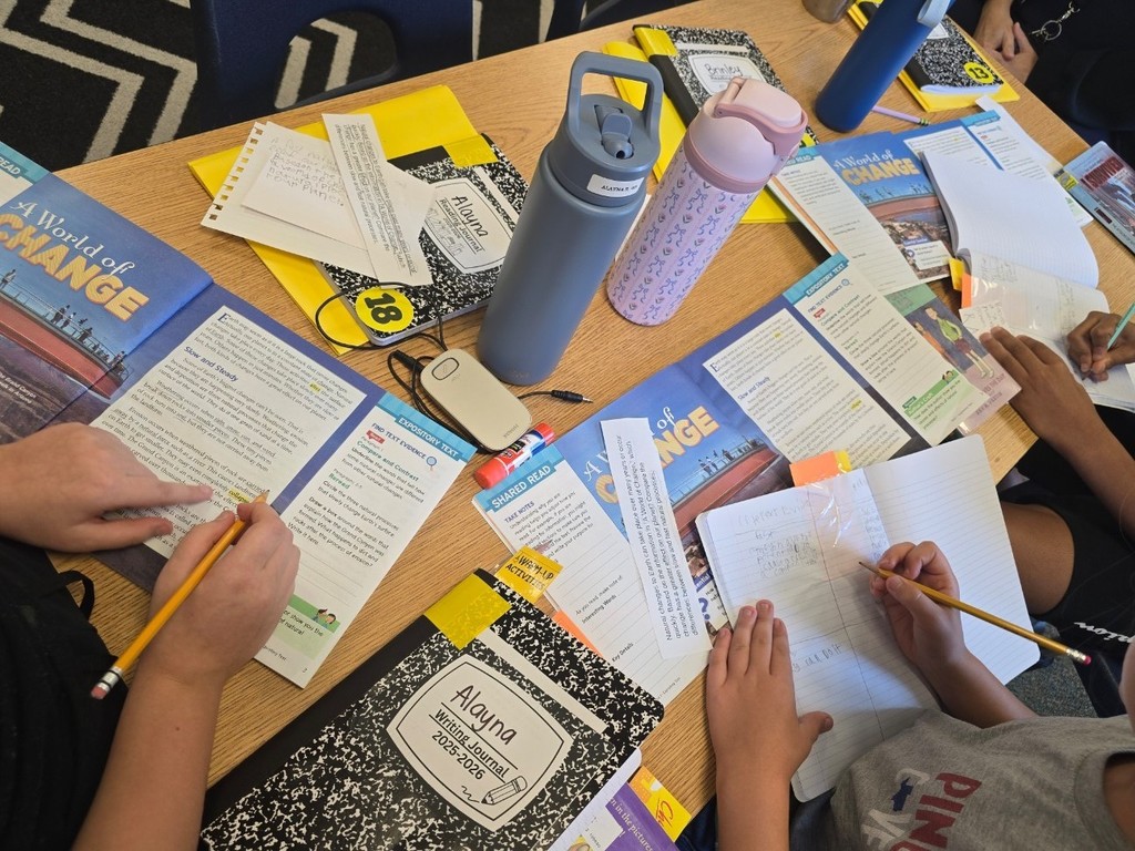 students writing in their notebooks