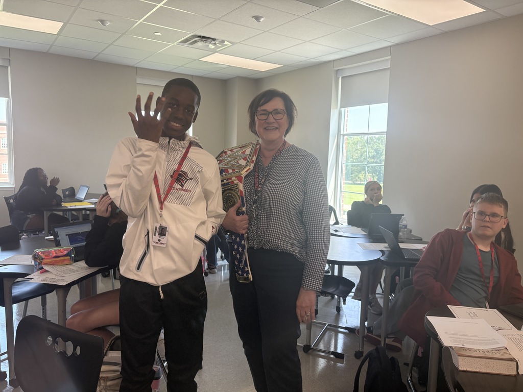 Mrs. Alexander and her student with her walk through wednesday winners belt