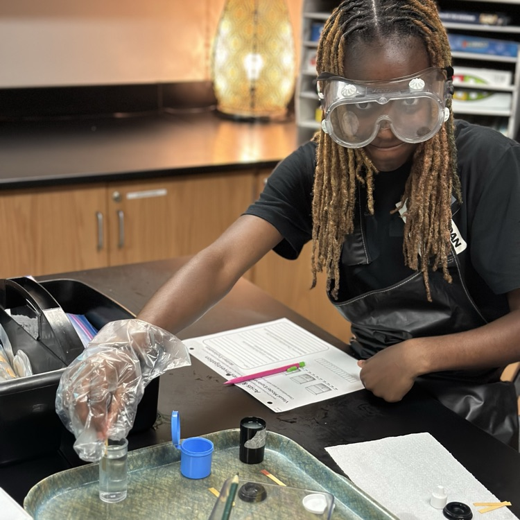 student investigating aqueous solutions