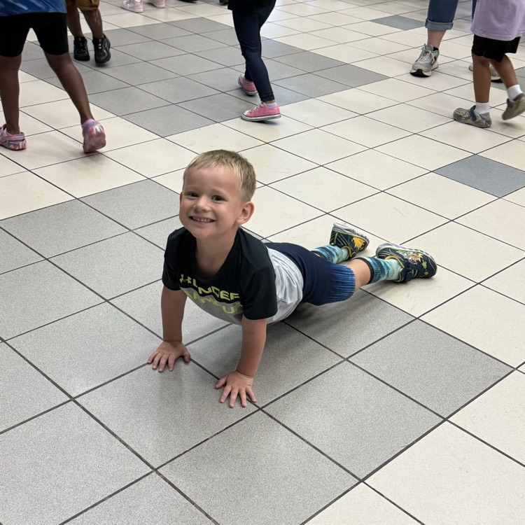 Student stretched out on the floor dancing at behavior party