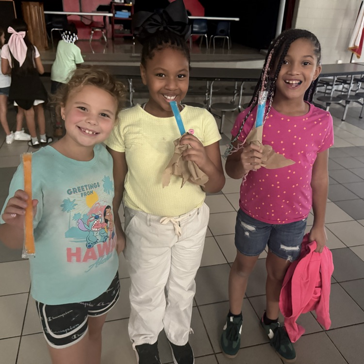 Students eating popsicles at a dance party