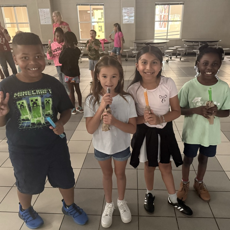 Students eating popsicles at a dance party