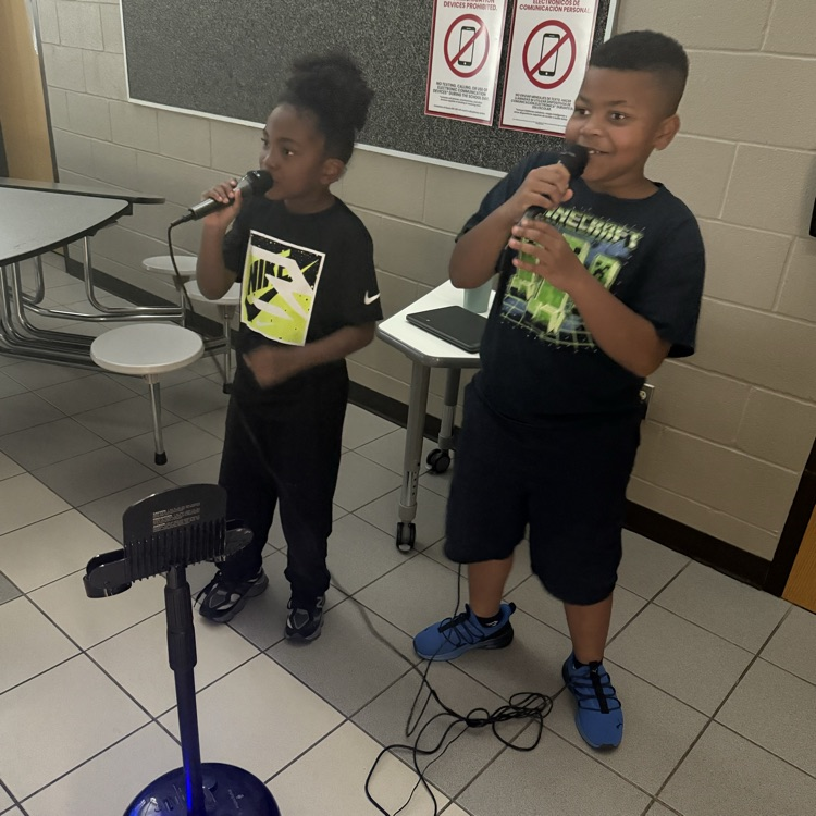 Two students singing karaoke